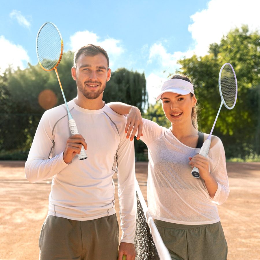 Two players with badminton rackets outdoors